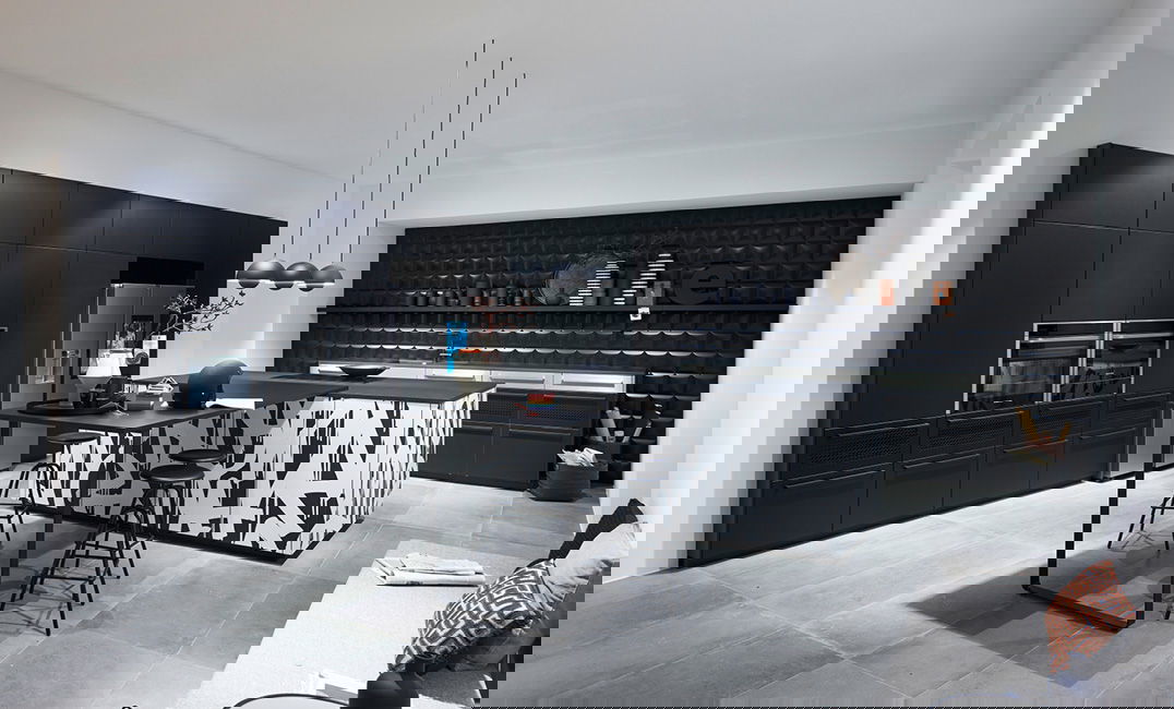 Moderne schwarz-weiße Küche mit geometrisch gemusterter Kochinsel.