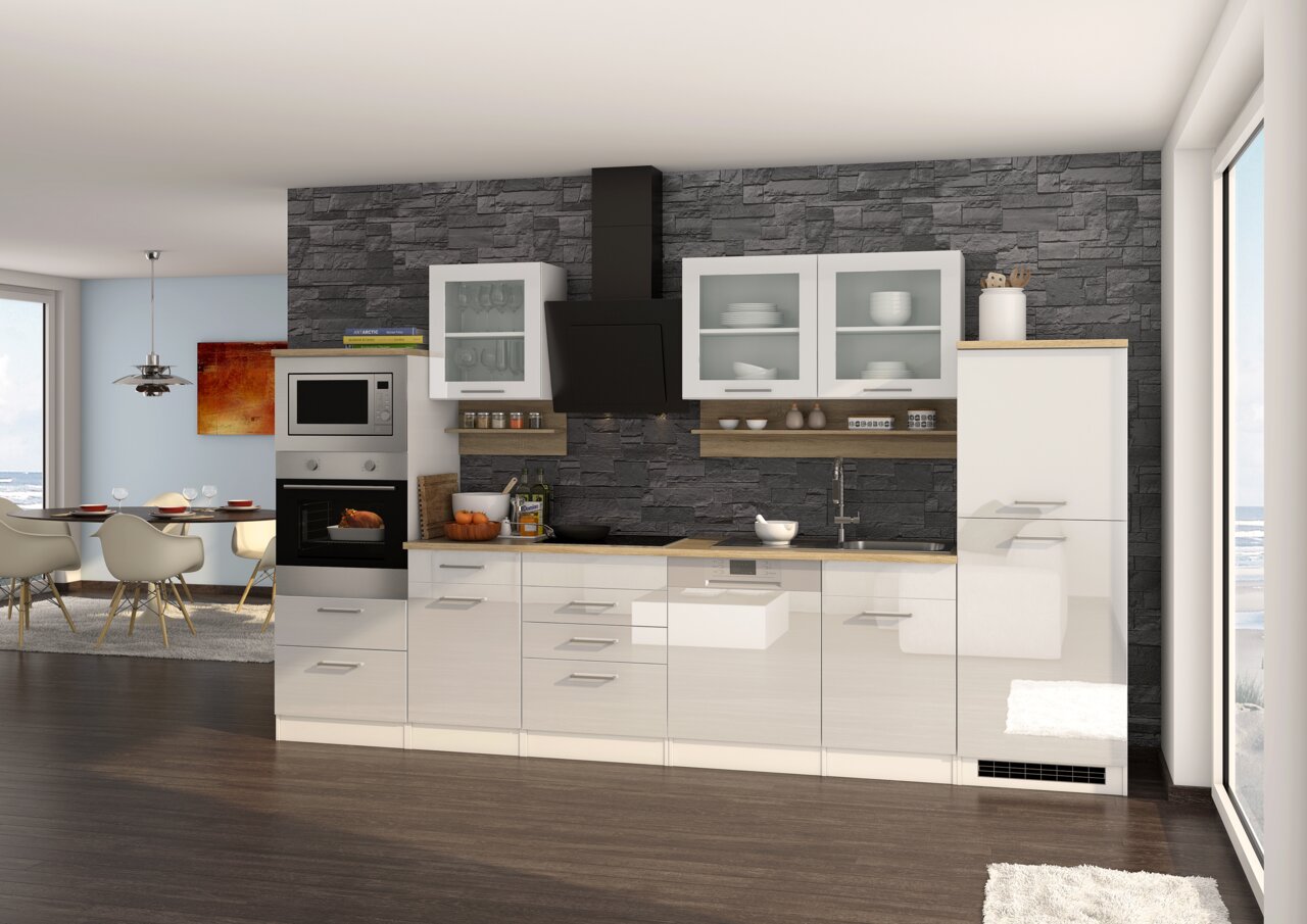 Moderne Küchenzeile mit weißen Hochglanzfronten, eingebautem Backofen und Mikrowelle, Glastüren und dunkler Steinwand im Hintergrund, seitliche Perspektive.