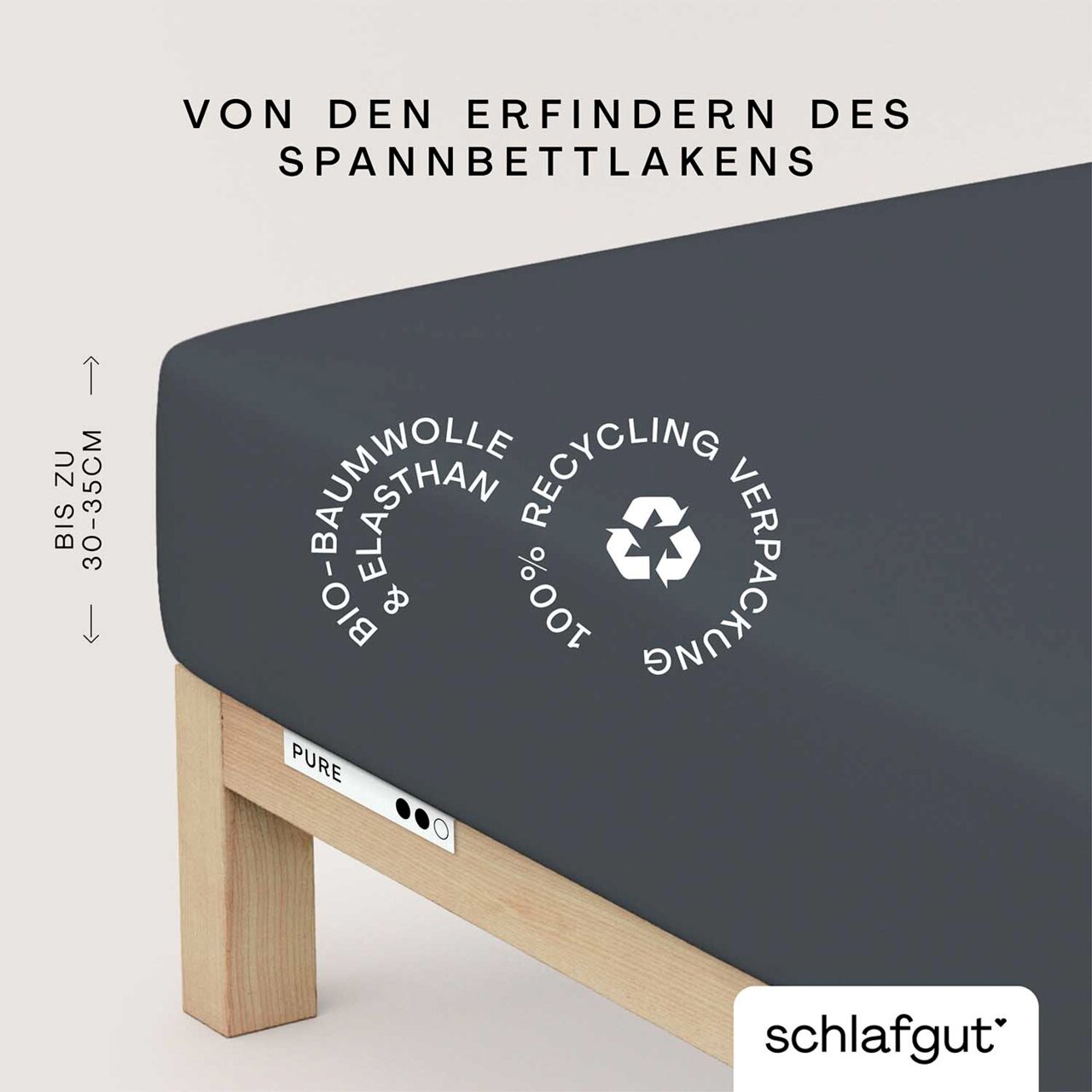 Spannbettlaken aus Bio-Baumwolle und Elasthan in dunkler Farbe, auf einem Bett mit Holzrahmen. Verpackung aus 100% Recyclingmaterial. Perspektive von der Seite.