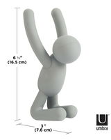 Grauer Wandhaken in Form einer stilisierten Figur, die auf den Knien sitzt und die Arme nach oben streckt, Seitenansicht.