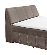 Boxspringbett in seitlicher Perspektive mit gepolstertem Kopfteil und weißer Matratze