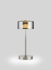 Moderne led-tafellamp met transparante lampenkap en metalen voet, gezien van voren.