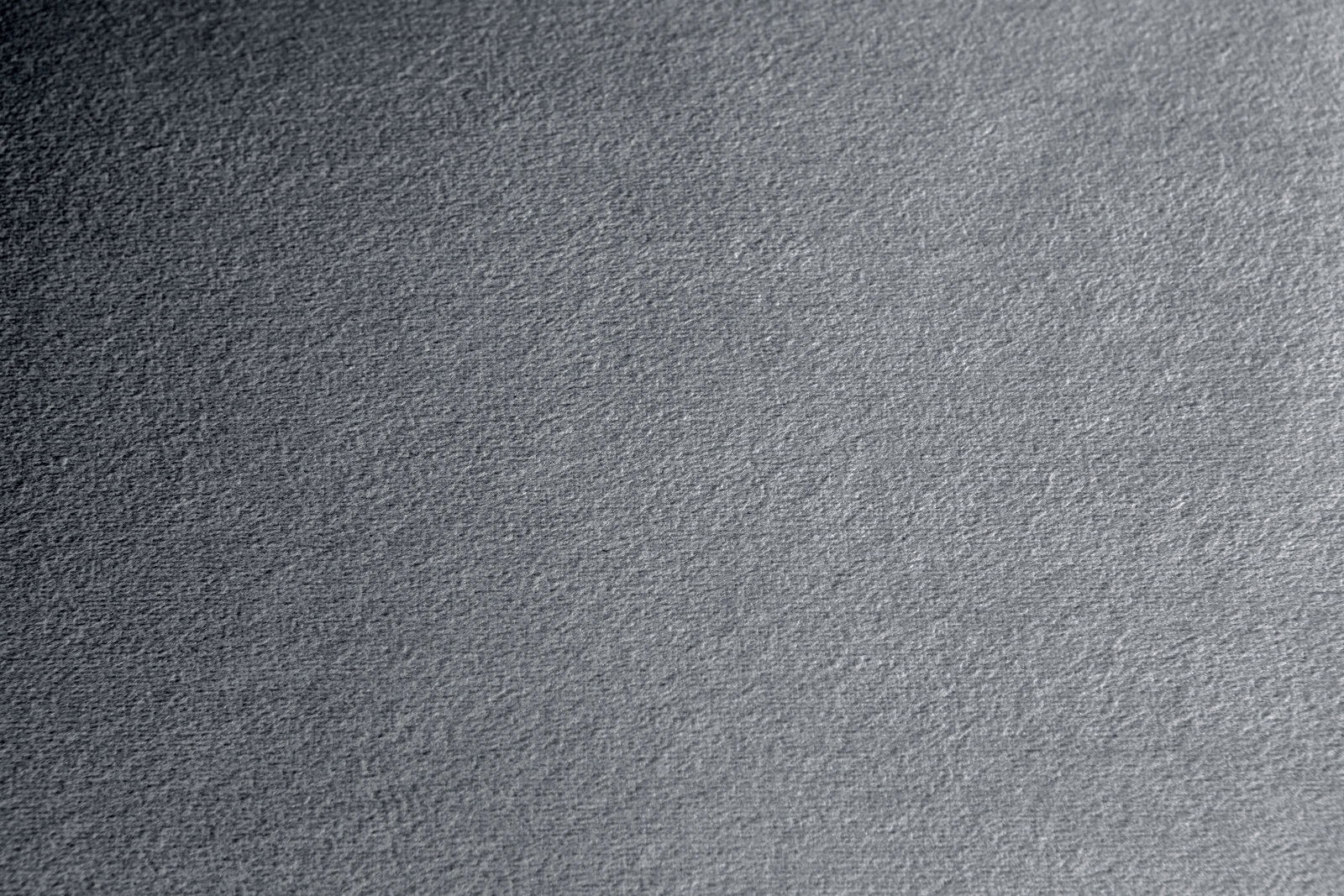 Nahaufnahme einer grauen Stoffoberfläche mit texturierter Struktur
