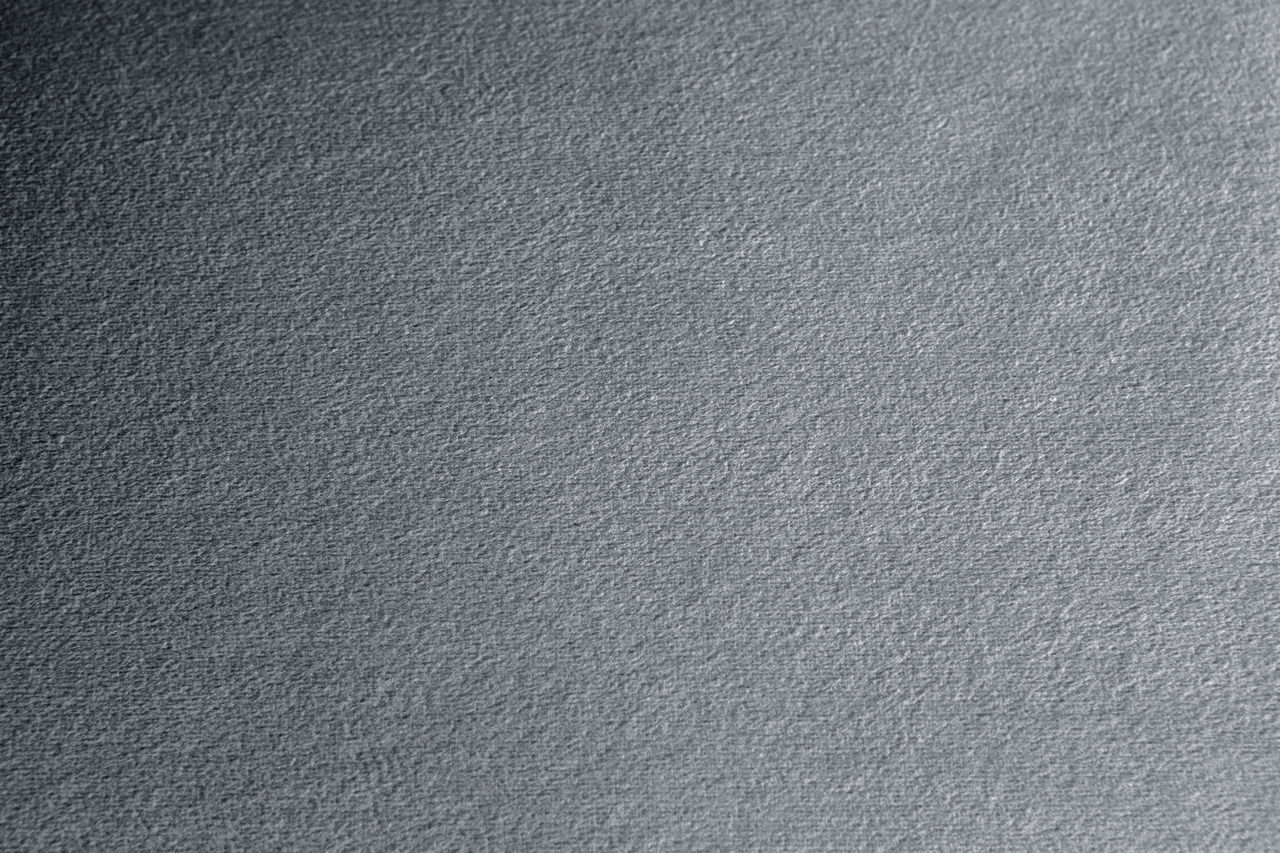Nahaufnahme einer grauen Stoffoberfläche mit texturierter Struktur