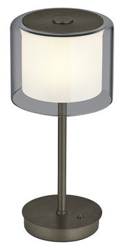 Moderne LED-Tischleuchte KLARA mit zylindrischem, transparentem Schirm und metallischem Standfuß, seitliche Perspektive