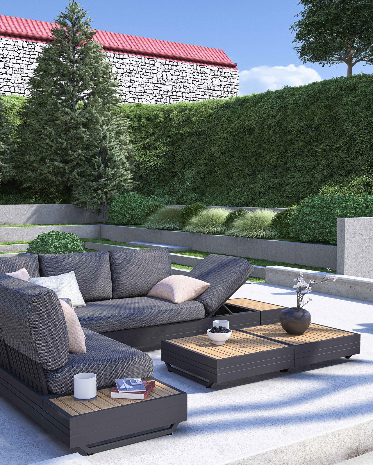 Moderne Gartenmöbel-Lounge mit 3-Sitzer Sofa, Loungesessel und Kaffeetischen in einem stilvollen Garten. Perspektive von schräg vorne.