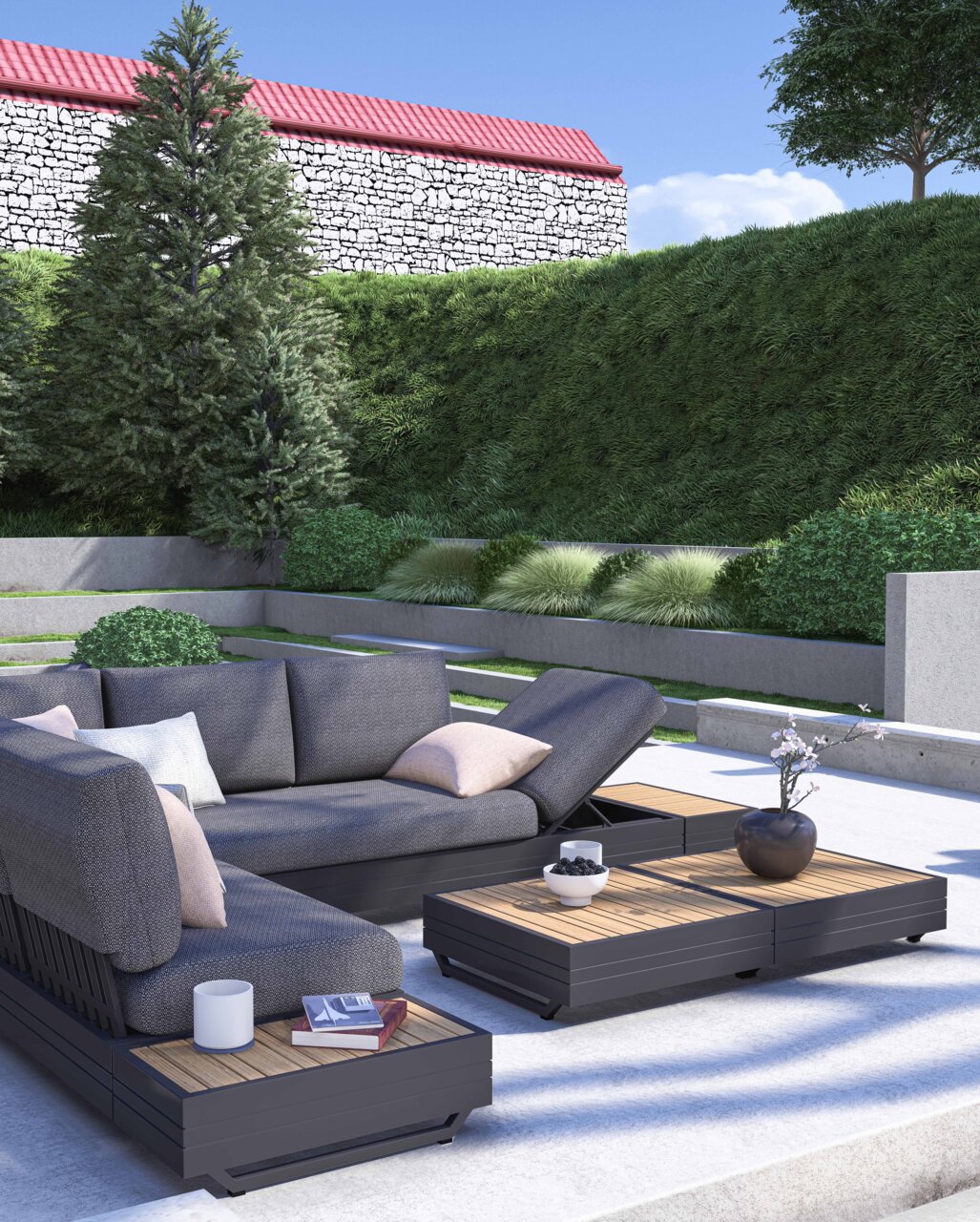 Moderne tuinmeubelset met een driezitsbank, loungestoelen en salontafels in een stijlvolle tuin. Aanzicht van schuin van voren.
