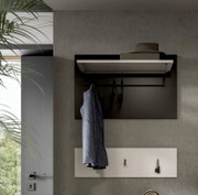 Moderne Wandgarderobe mit Ablageboard und Kleiderstange, schwarzes Paneel mit Bügeln und hängendem Mantel über weißer Schlüsselablage, frontale Ansicht