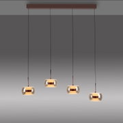 Moderne 4-flammige Pendelleuchte mit brauner Deckenleiste, langen schwarzen Kabeln und runden Rauchglas-Schirmen mit warmem Licht und kupferfarbenem Mittelband, Frontansicht leicht von unten