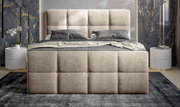 Vooraanzicht van een elegant boxbed met gestoffeerd hoofdeinde in een moderne slaapkamer.