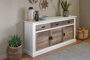 Sideboard mit weißem Rahmen und Holztüren, dekoriert mit Pflanzen und Vasen, aus seitlicher Perspektive fotografiert.