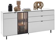 Modernes weißes Sideboard mit mehreren Schubladen und einer Glastür, dekoriert mit Vasen und Büchern, seitliche Perspektive.