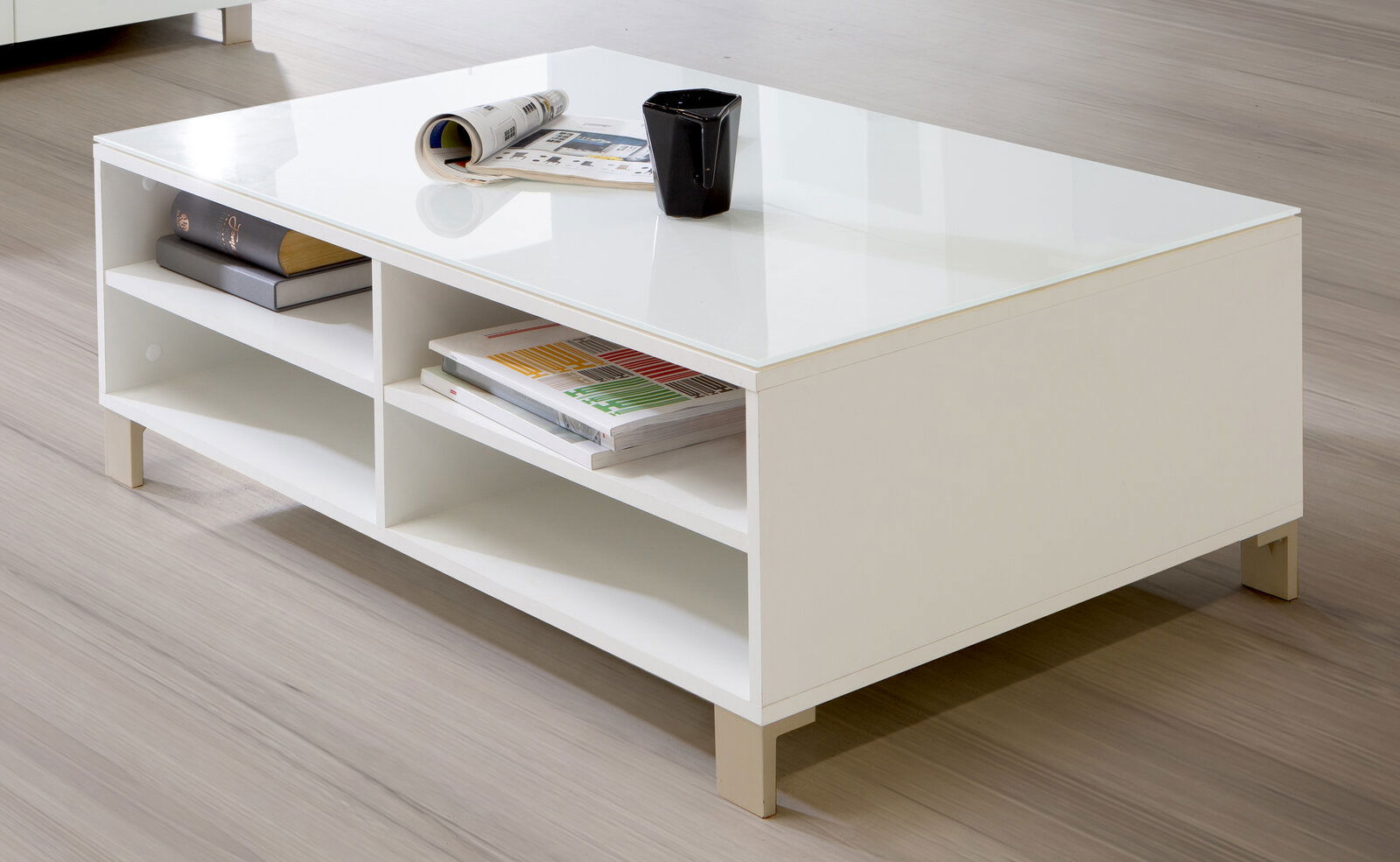 Moderner weißer Couchtisch mit glänzender Oberfläche und offenen Regalfächern, seitliche Perspektive
