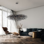 Moderne kroonluchter ICICLE in een stijlvolle woonkamer, van onderaf gezien, met hangende kristallen en warm licht.