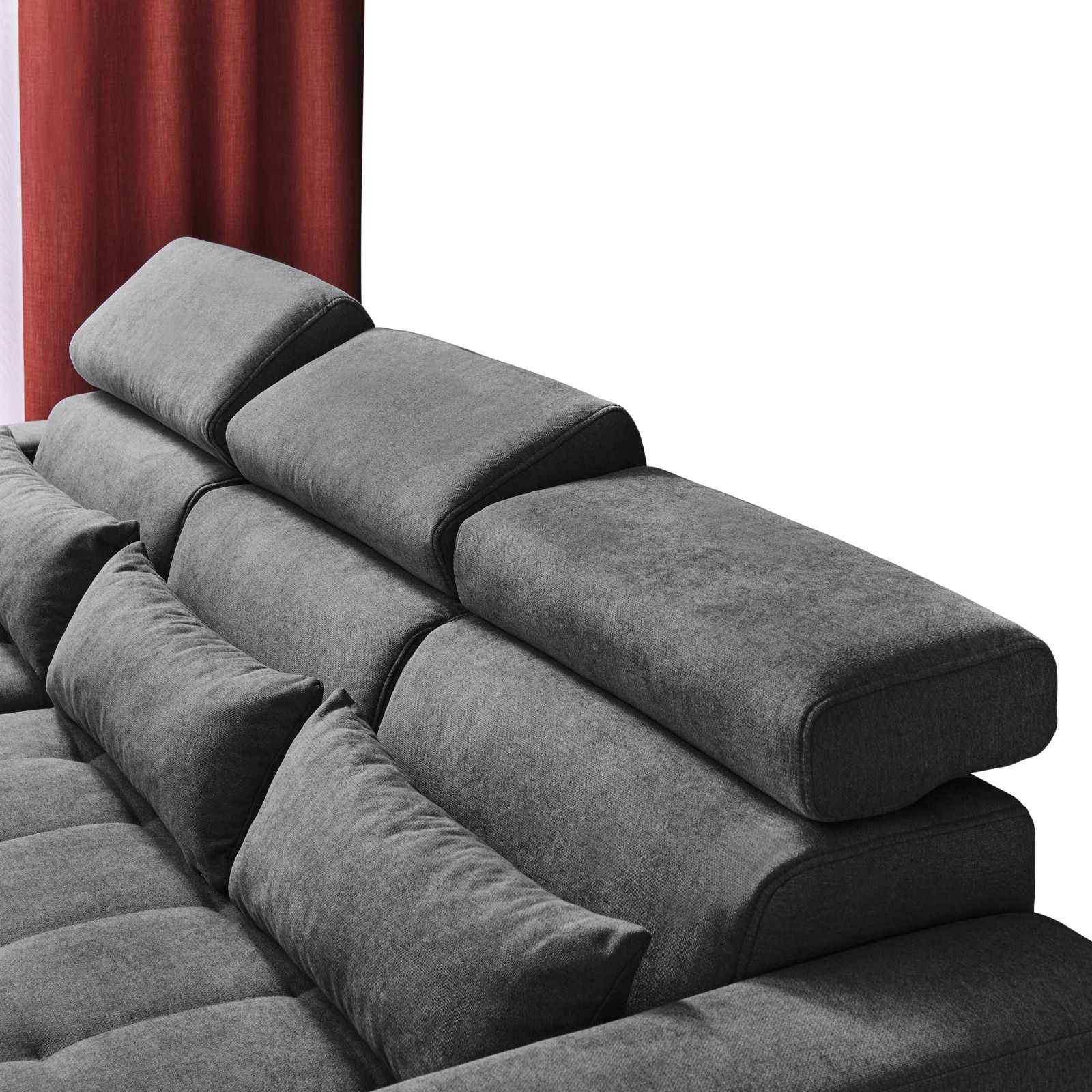 Graues Sofa mit verstellbaren Kopfstützen und Kissen, seitliche Perspektive