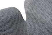 Nahaufnahme eines grauen Sessels mit texturierter Stoffoberfläche, seitliche Perspektive