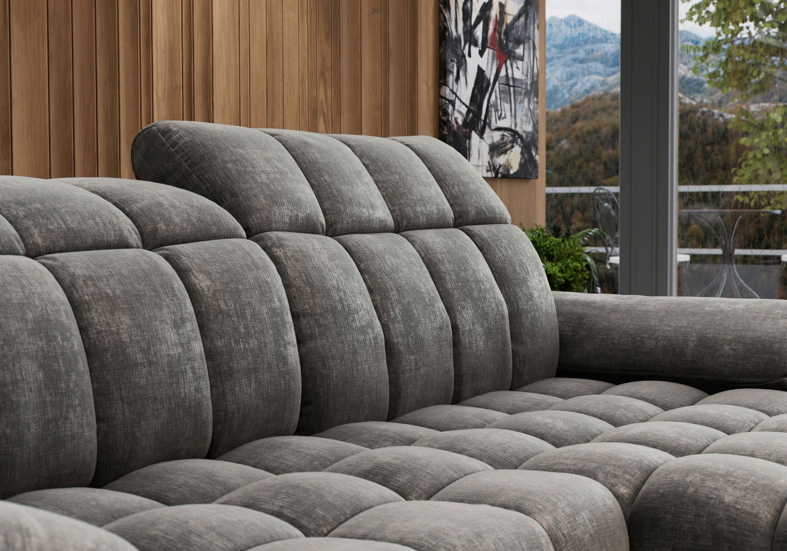 Graues, gepolstertes Longchair-Sofa in einer modernen Wohnumgebung, seitliche Perspektive.