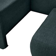 Nahaufnahme einer dunkelgrünen Recamiere mit strukturiertem Stoff, von oben betrachtet.