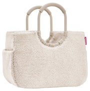 Beige tas van zacht materiaal met twee stevige handvatten, zijaanzicht