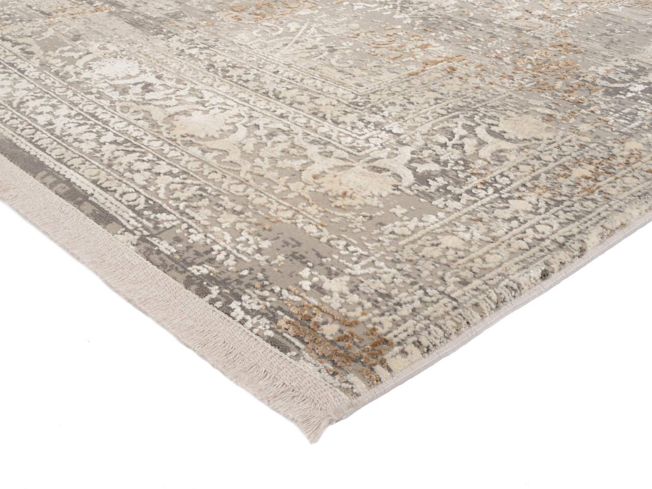 Nahaufnahme eines Designer-Teppichs mit detailliertem Muster in Beige- und Grautönen, perspektivisch von der Ecke aufgenommen.
