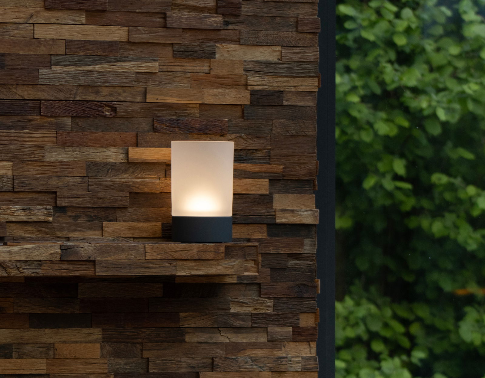 Akku-Windlicht auf einer rustikalen Holzverkleidung, seitliche Perspektive