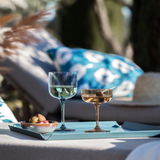 Zwei elegante Sekt- und Dessertschalen auf einem Tablett im Freien, seitliche Perspektive