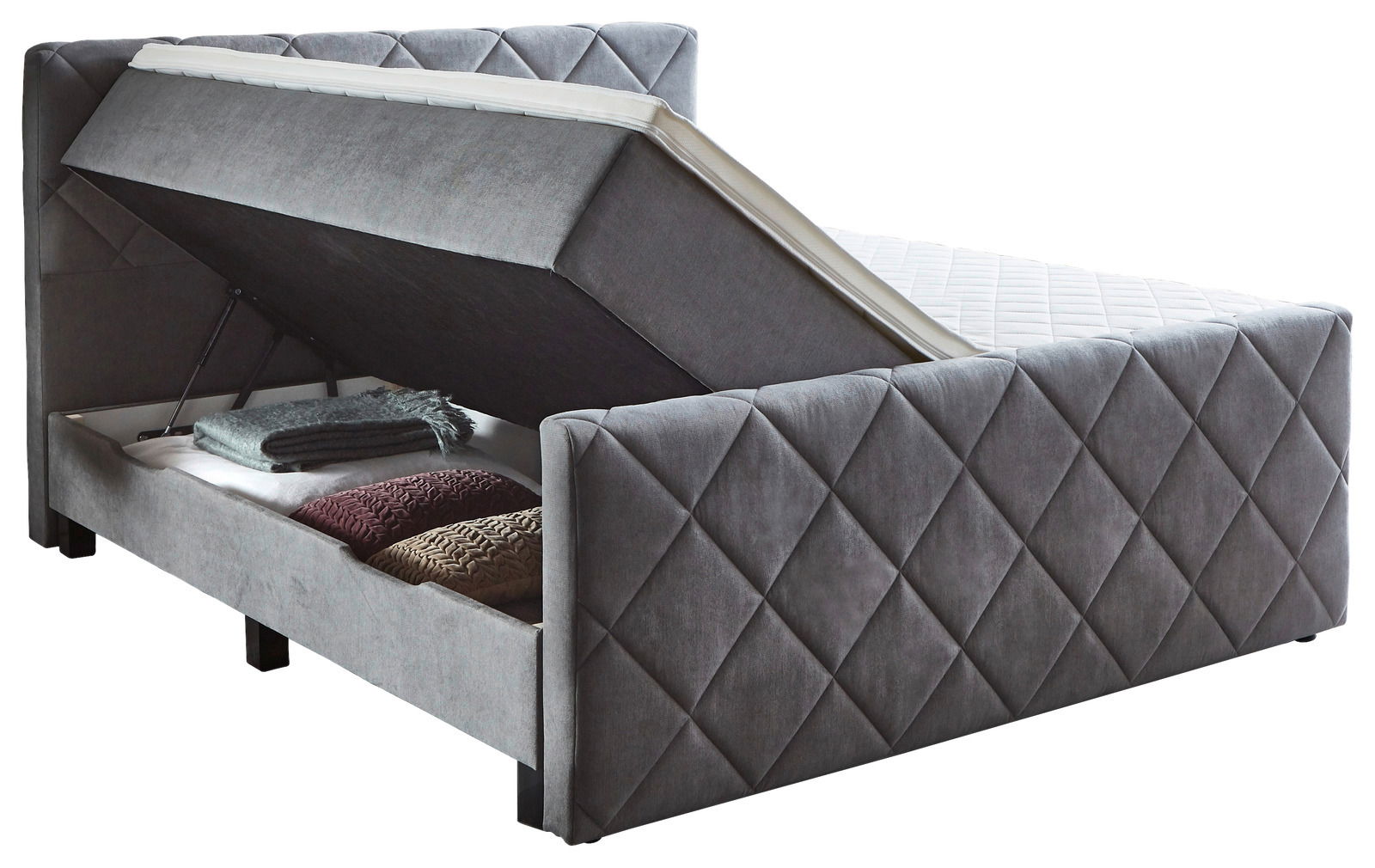 Boxspringbett BX2200 CHESTER in seitlicher Perspektive mit geöffnetem Bettkasten und Stauraum für Decken und Kissen.