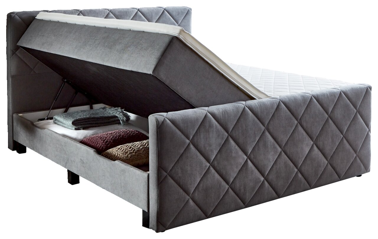 Boxspringbett BX2200 CHESTER in seitlicher Perspektive mit geöffnetem Bettkasten und Stauraum für Decken und Kissen.