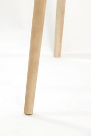 Nahaufnahme eines Holzbeins einer Stehleuchte, von der Seite betrachtet.