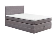 Graues Boxspringbett XORA HAWAII in seitlicher Perspektive mit gestepptem Kopfteil und weißer Matratze.