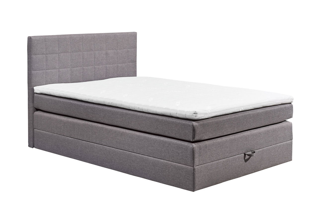 Graues Boxspringbett XORA HAWAII in seitlicher Perspektive mit gestepptem Kopfteil und weißer Matratze.