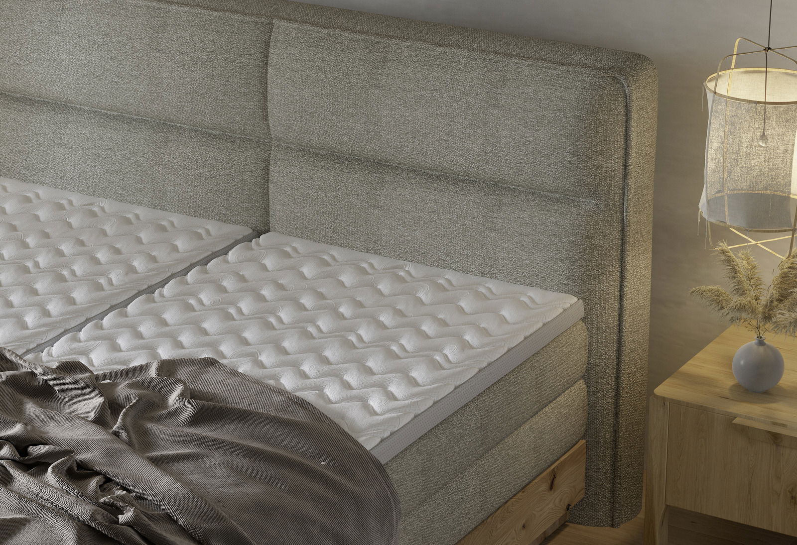 Boxspringbett mit grauem Kopfteil und weißer Matratze, seitliche Perspektive