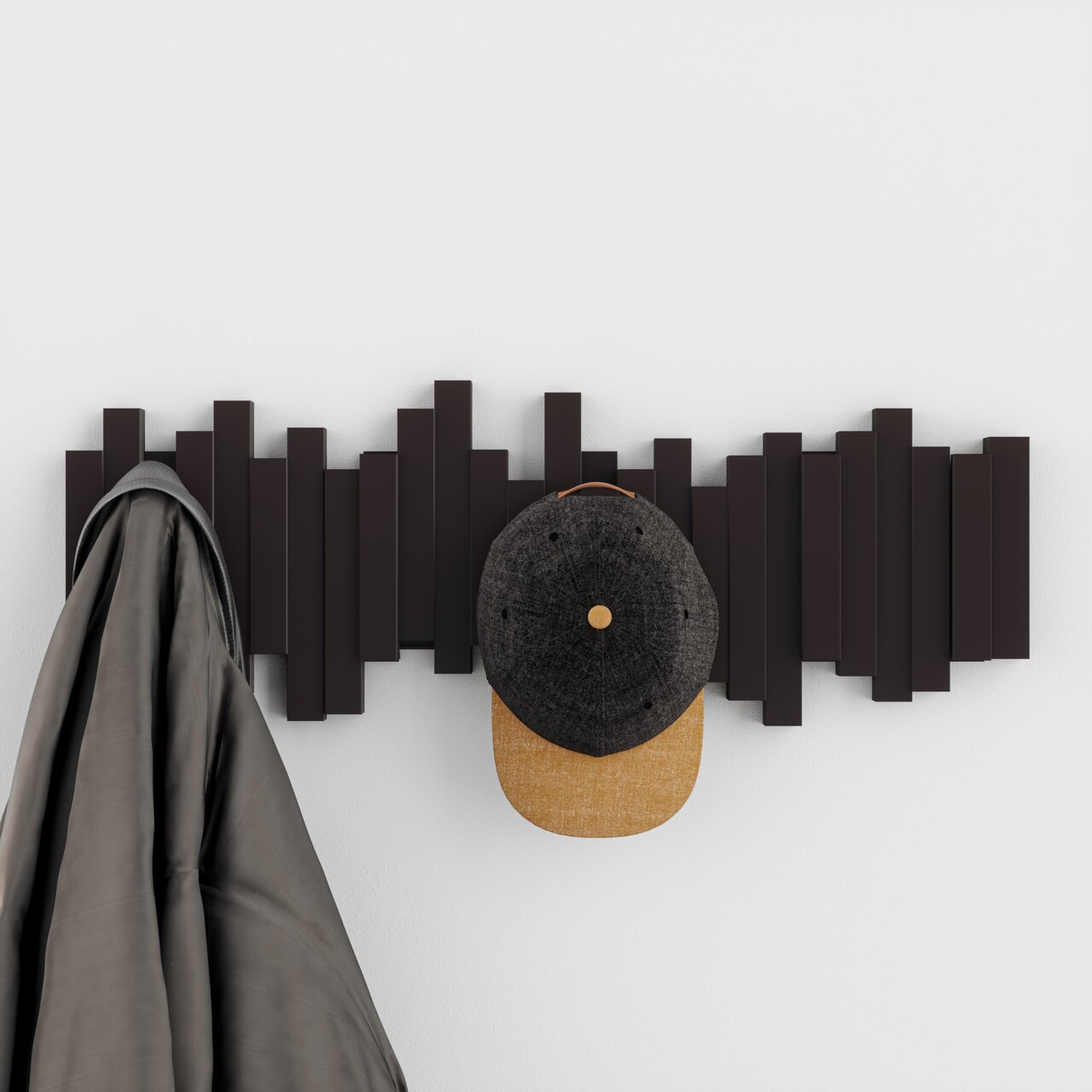 Moderne Wandgarderobe mit geometrischem Design, frontal fotografiert, mit einem Mantel und einer Mütze daran aufgehängt.