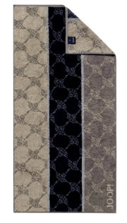 JOOP! Handtuch SIGNATURE in einer Draufsicht, mit einem eleganten Muster in Beige- und Grautönen sowie einem schwarzen Streifen.