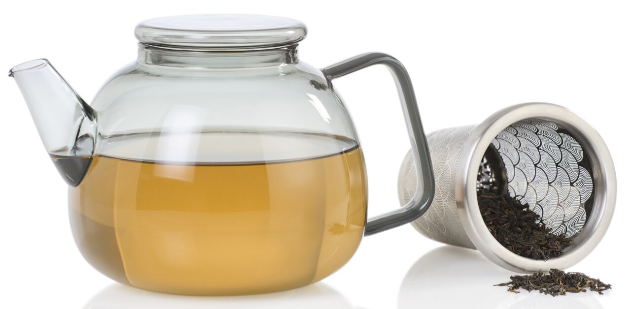 Glazen theepot Yuna met een inhoud van 1,2 liter, zijaanzicht, naast een theezeefje met losse thee.