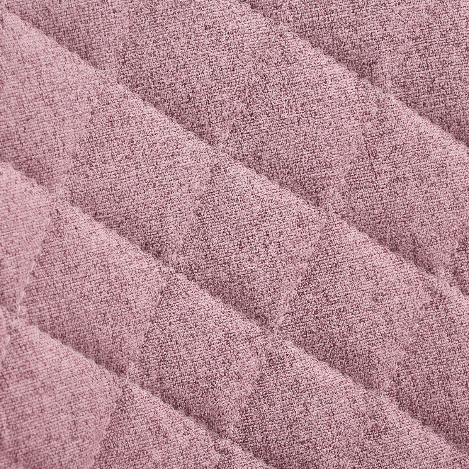 Nahaufnahme eines rosa gepolsterten Stoffes mit rautenförmigem Steppmuster, Draufsicht