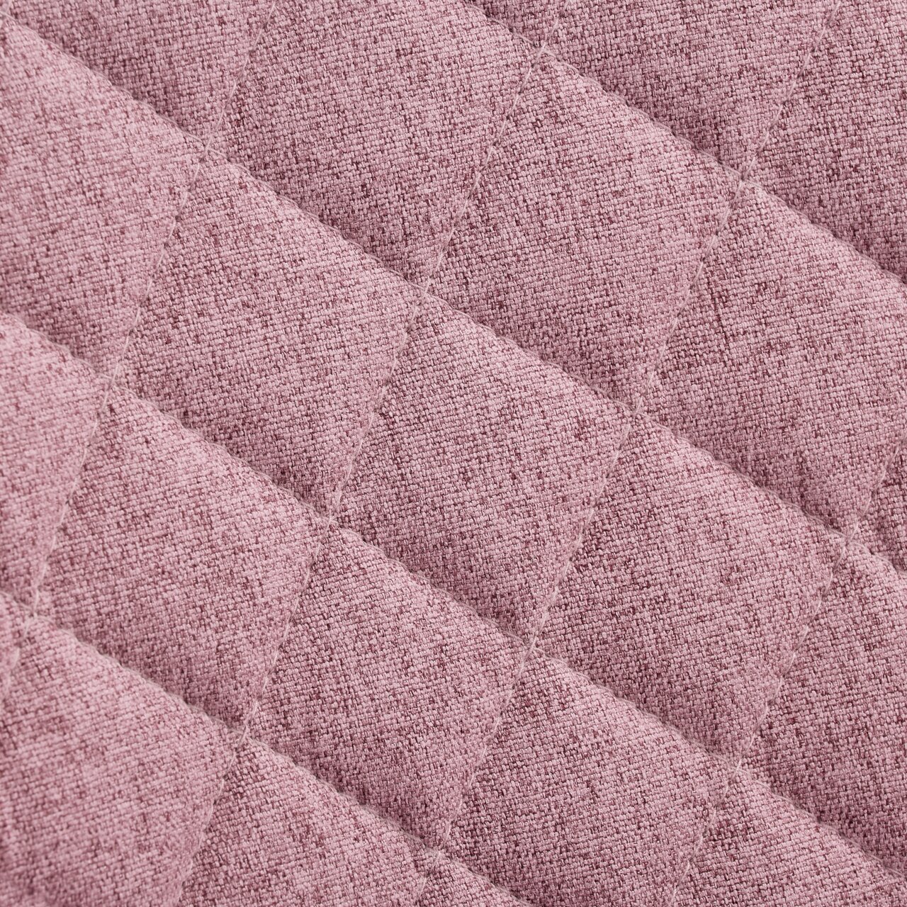 Nahaufnahme eines rosa gepolsterten Stoffes mit rautenförmigem Steppmuster, Draufsicht