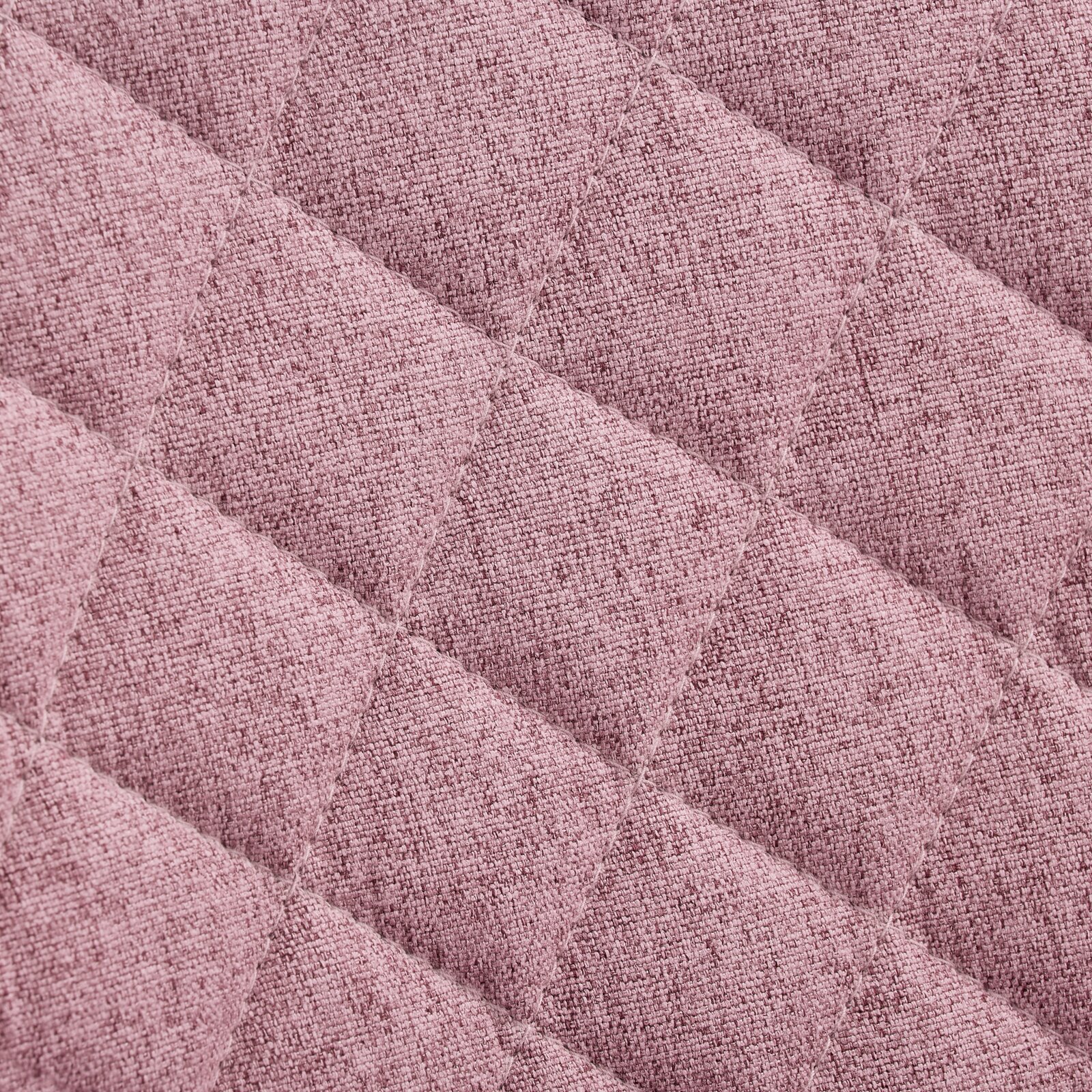 Nahaufnahme eines rosa gepolsterten Stoffes mit rautenförmigem Steppmuster, Draufsicht