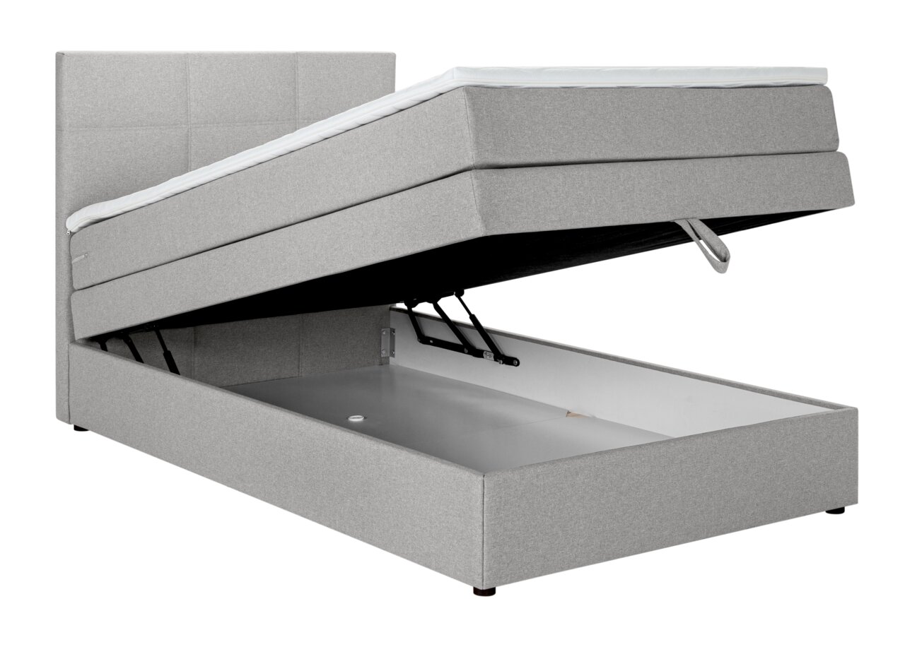 Graues Boxspringbett mit hochgeklappter Matratze und sichtbarem Stauraum, seitliche Perspektive