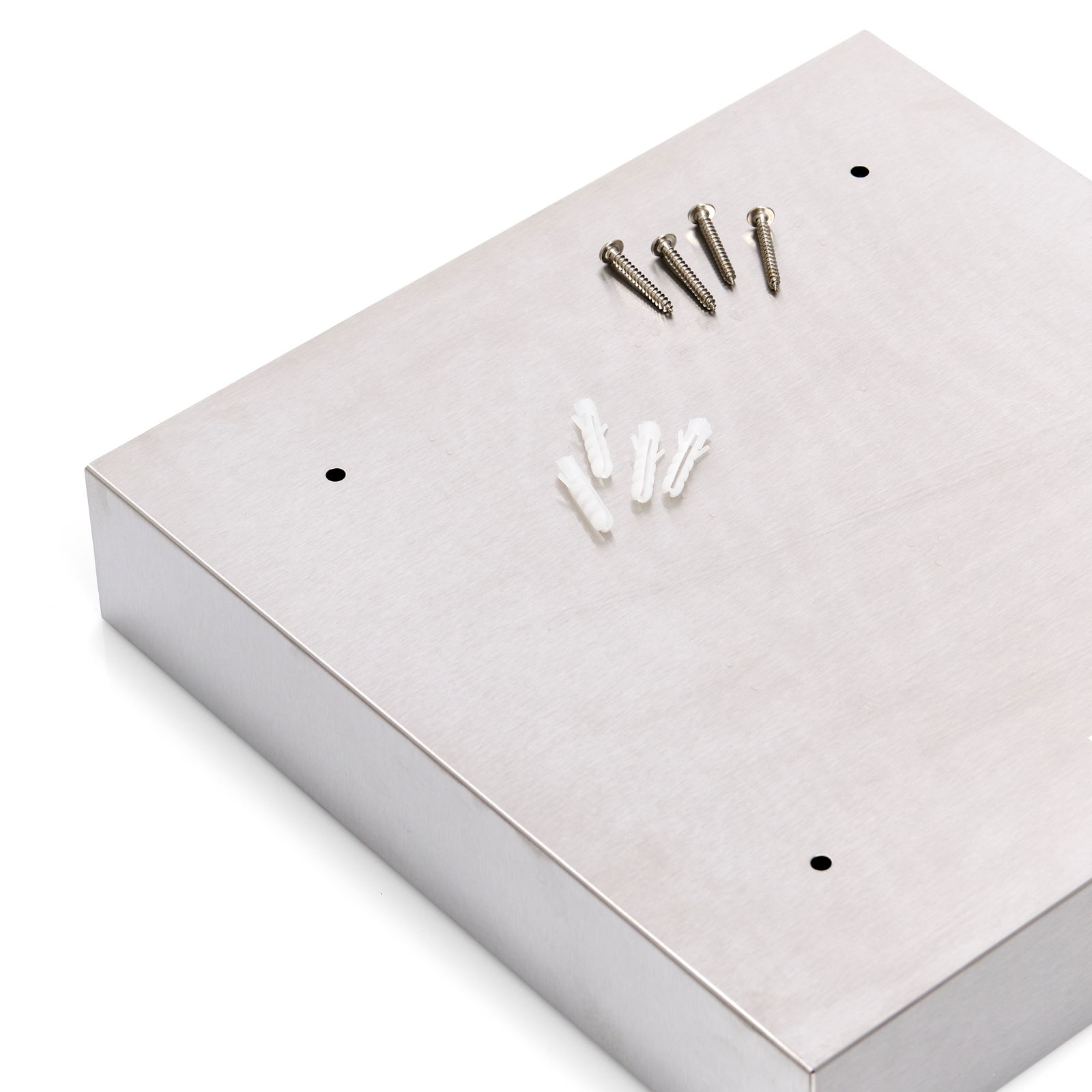 Schlüsselkasten aus Metall in schräger Draufsicht mit Schrauben und Dübeln auf der Oberseite.