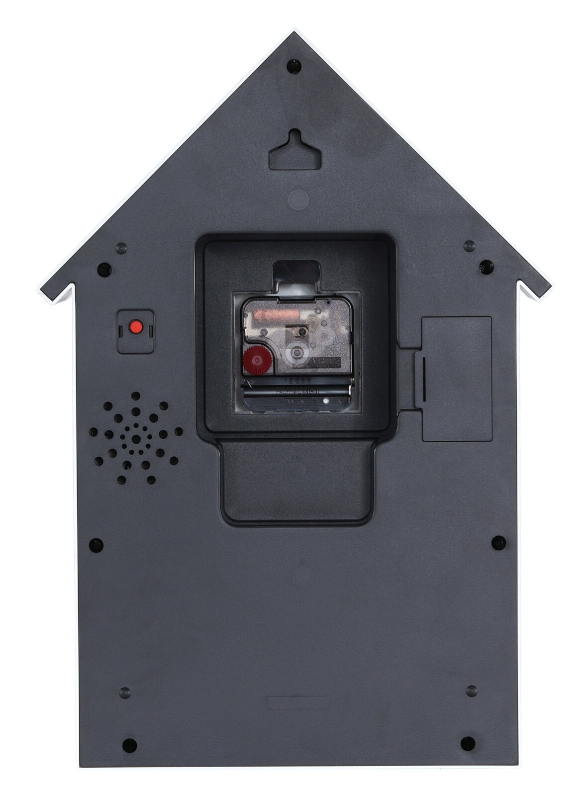 Rückansicht einer Wanduhr in Form eines Hauses mit sichtbarem Uhrwerk und Lautsprecher.