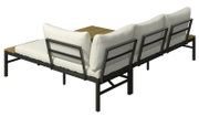 Achterkant van een loungeset met vier witte kussens op een zwart metalen frame en een houten tafel in het midden.