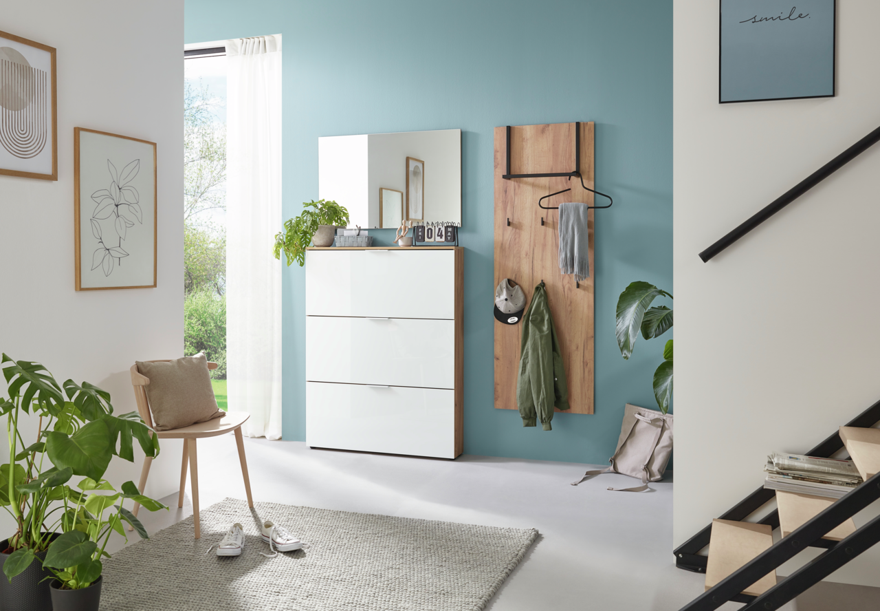 Moderner Eingangsbereich mit Garderobenpaneel und Schuhschrank in hellem Holz und Weiß, seitliche Perspektive