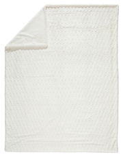 Weiße Felldecke in Draufsicht mit umgeschlagener Ecke