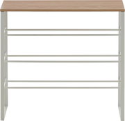 Schmales Schuhregal mit weißem Metallgestell, mehreren Ablageebenen und Holzplatte oben, frontale Ansicht.