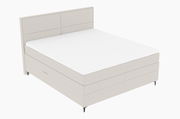 Boxspringbett in seitlicher Perspektive mit hellem Stoffbezug und schlichtem Design.
