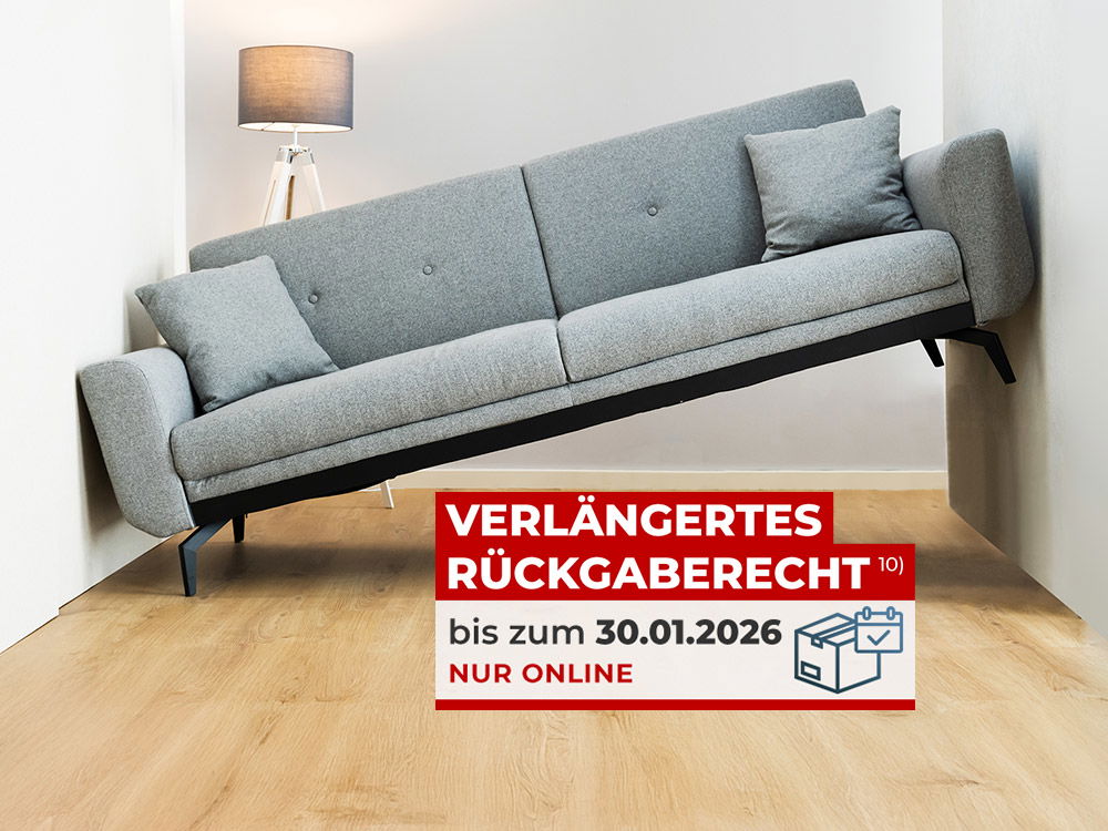 Graues Sofa steckt in einem zu engen Raum fest - verlängertes Rückgaberecht