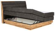 Boxspringbett mit hochgeklappter Matratze und Stauraum, seitliche Perspektive