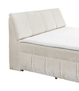 Beiges Boxspringbett mit gepolstertem Kopfteil, seitliche Perspektive