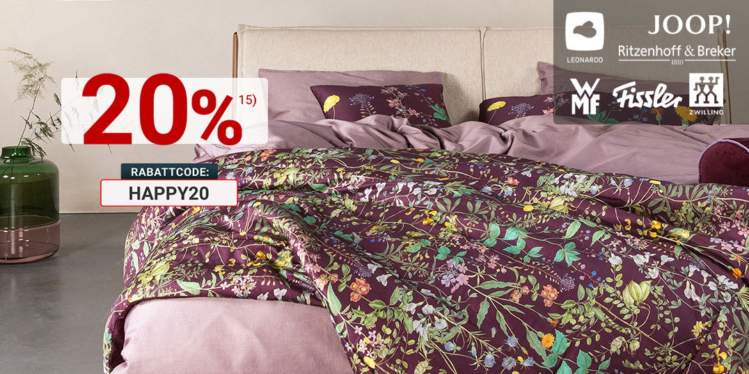 Modernes Schlafzimmer mit floraler Bettwäsche in Violett, Markenlogos von Joop!, WMF, Fissler und Zwilling